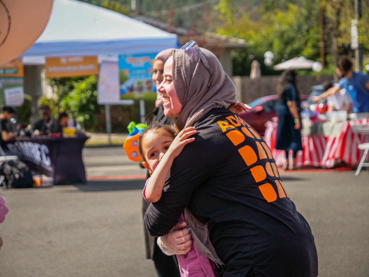 A Bamrec staff member greeting a family at an event